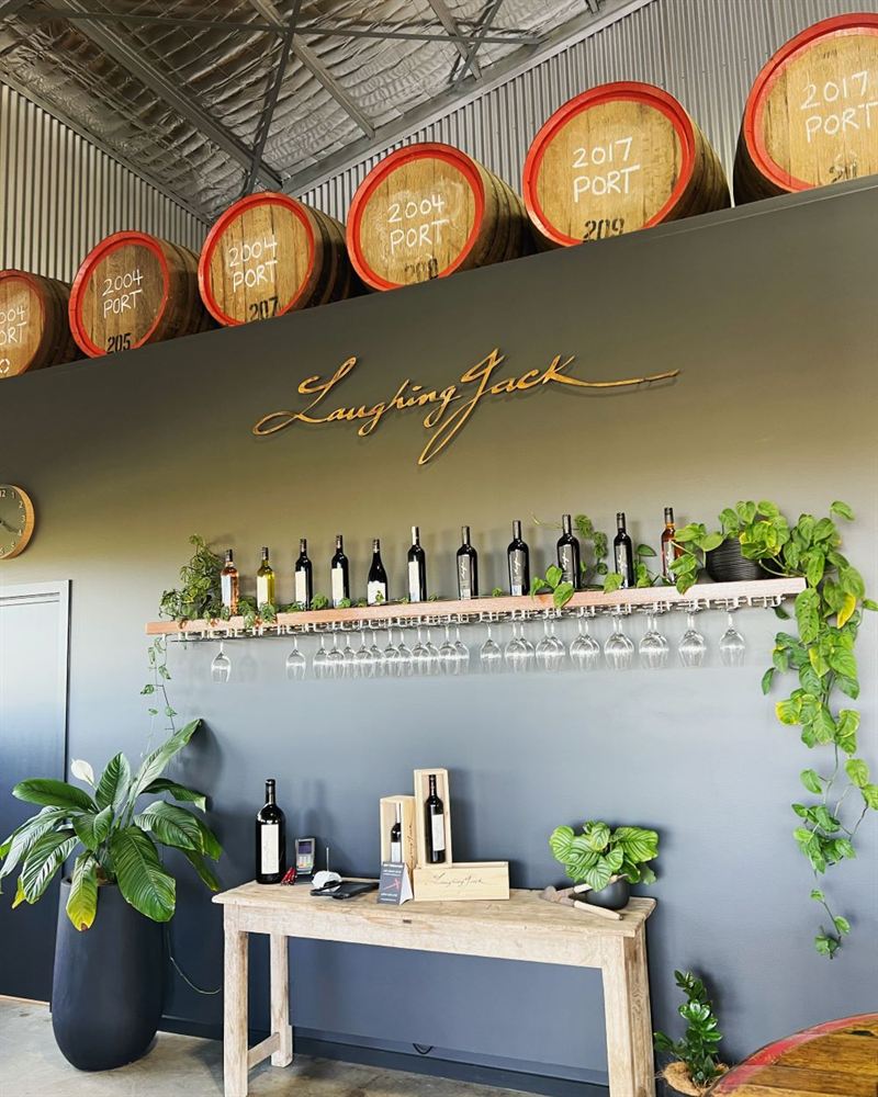an elegant foyer of wine barrels and plants