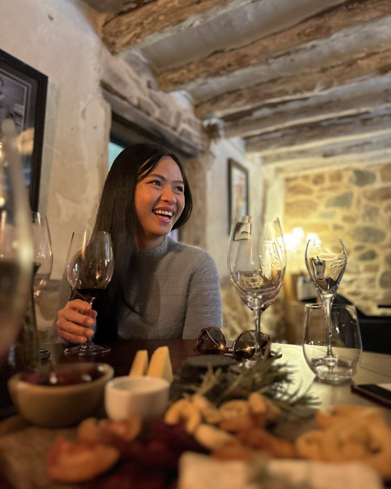 guest laughing over a glass of red at a barossa winery dinner