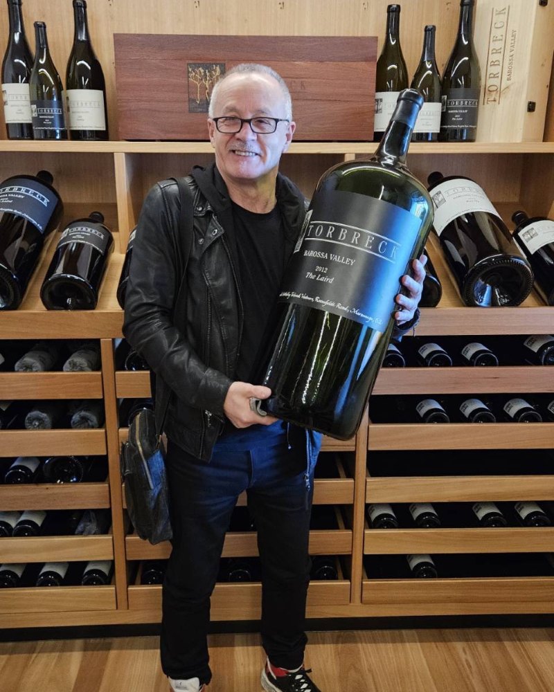 guest holding a giant bottle of wine at a barossa cellar door
